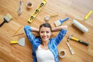 woman lying on floor next to home improvement tools
