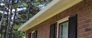 gutter guards on the outside of a brick home